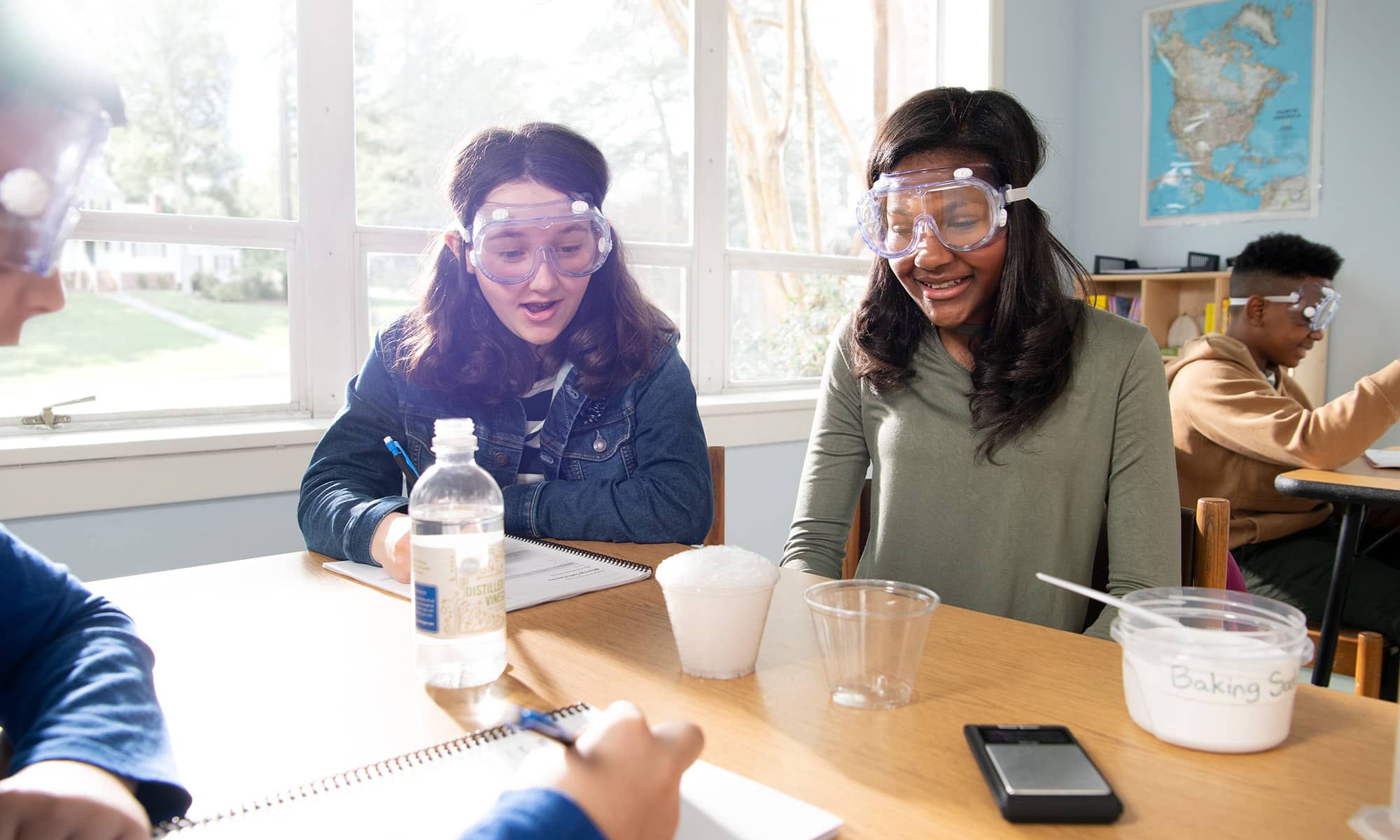 Several students conducting a hands-on investigation involving shaving cream